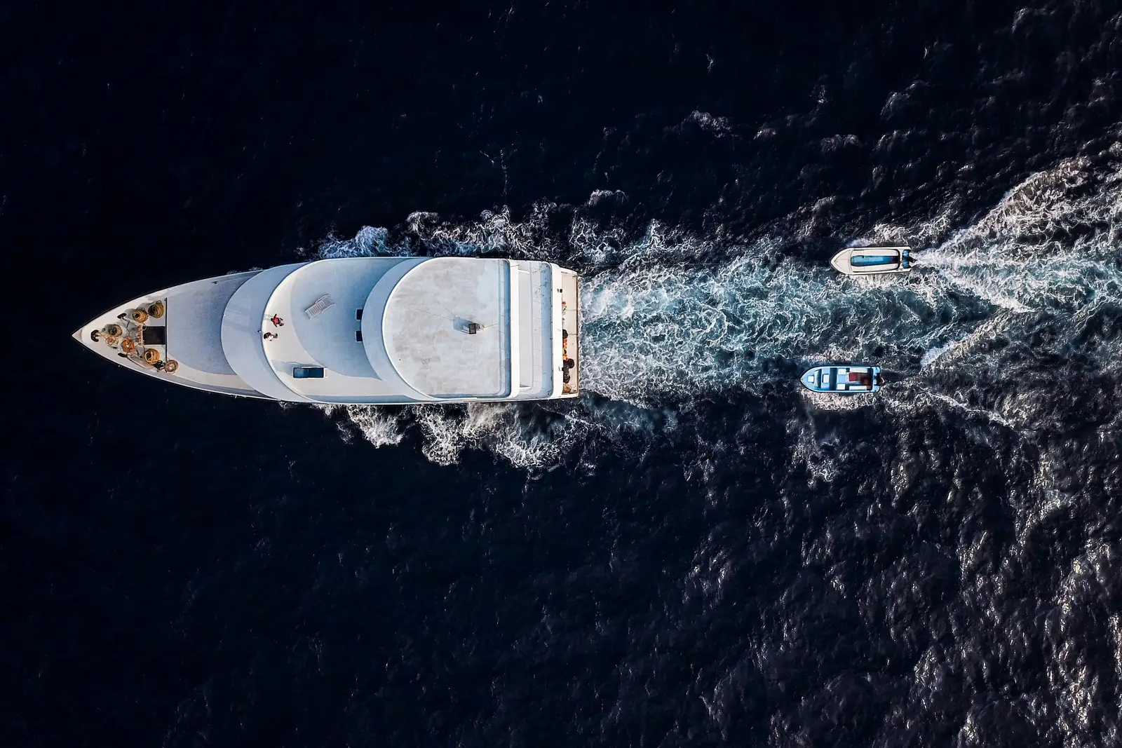 Aerial view of a motor yacht and its foaming wake